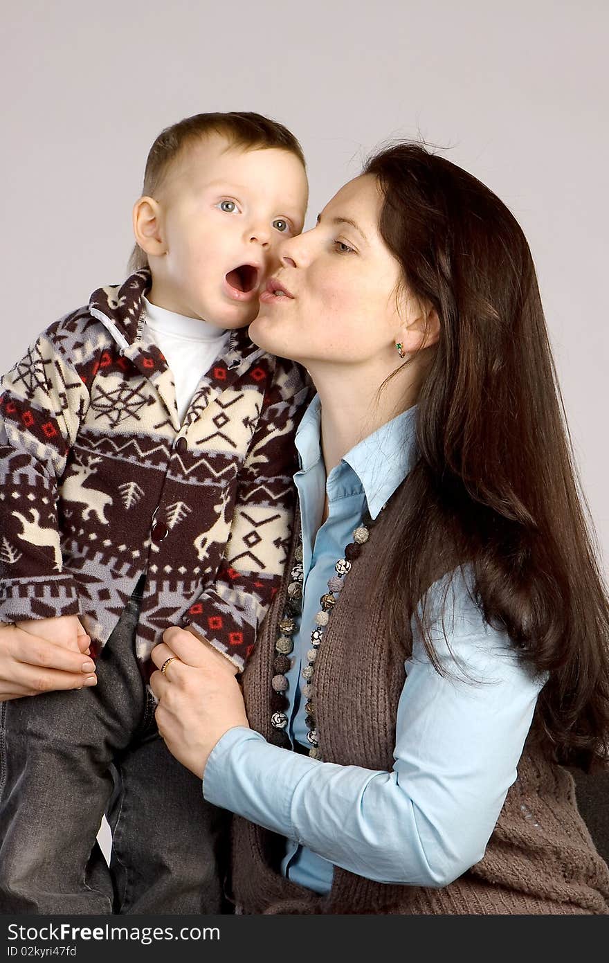 Smiling mother with son, studio shot, gray background