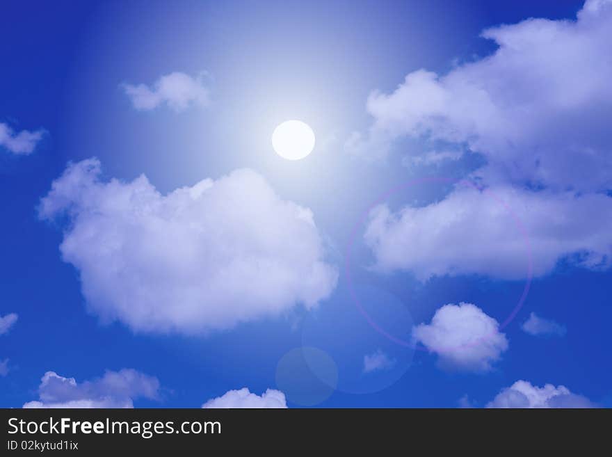 Image of direct sunlight with clouds in a blue sky. Image of direct sunlight with clouds in a blue sky