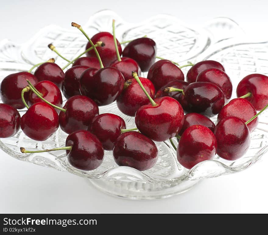 Fresh Cherries In A Glass Dish On A White Background