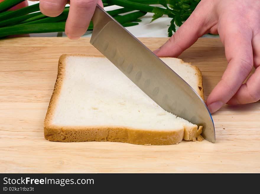 Piece of bread cut on the board to sandwich