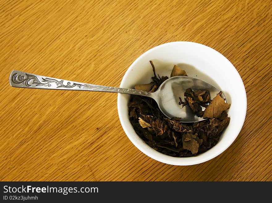 Spoon lying in a bowl in which tobacco lies. Spoon lying in a bowl in which tobacco lies