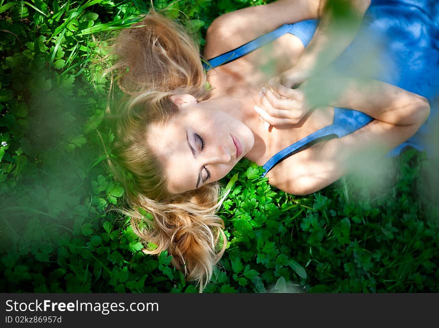 Girl lying on the green grass field