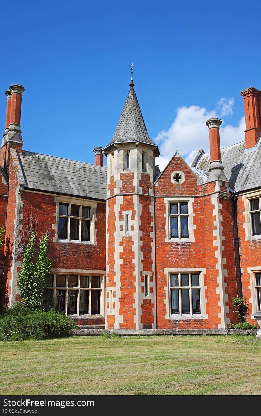 An imposing English Stately Home with Norman style Tower and tall chimneys and Mullion windows. An imposing English Stately Home with Norman style Tower and tall chimneys and Mullion windows