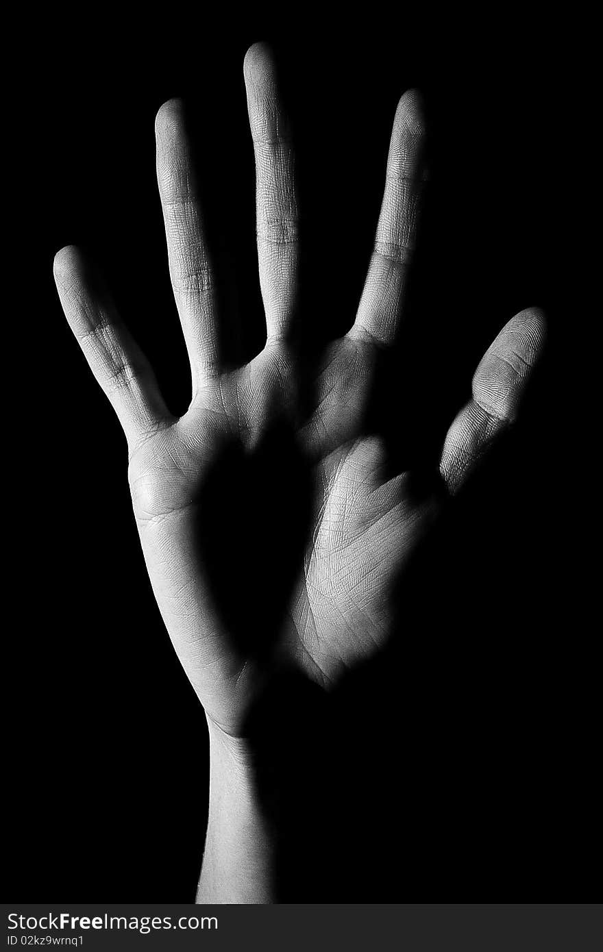 Human hand is drawn by light on a black background