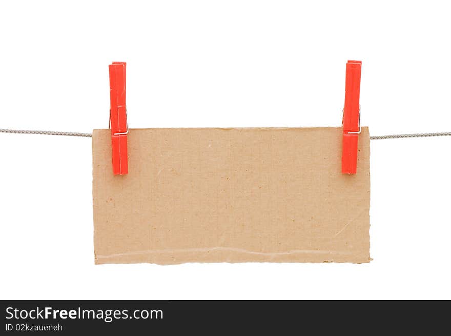 The cardboard tablet hangs on a cord isolated over white