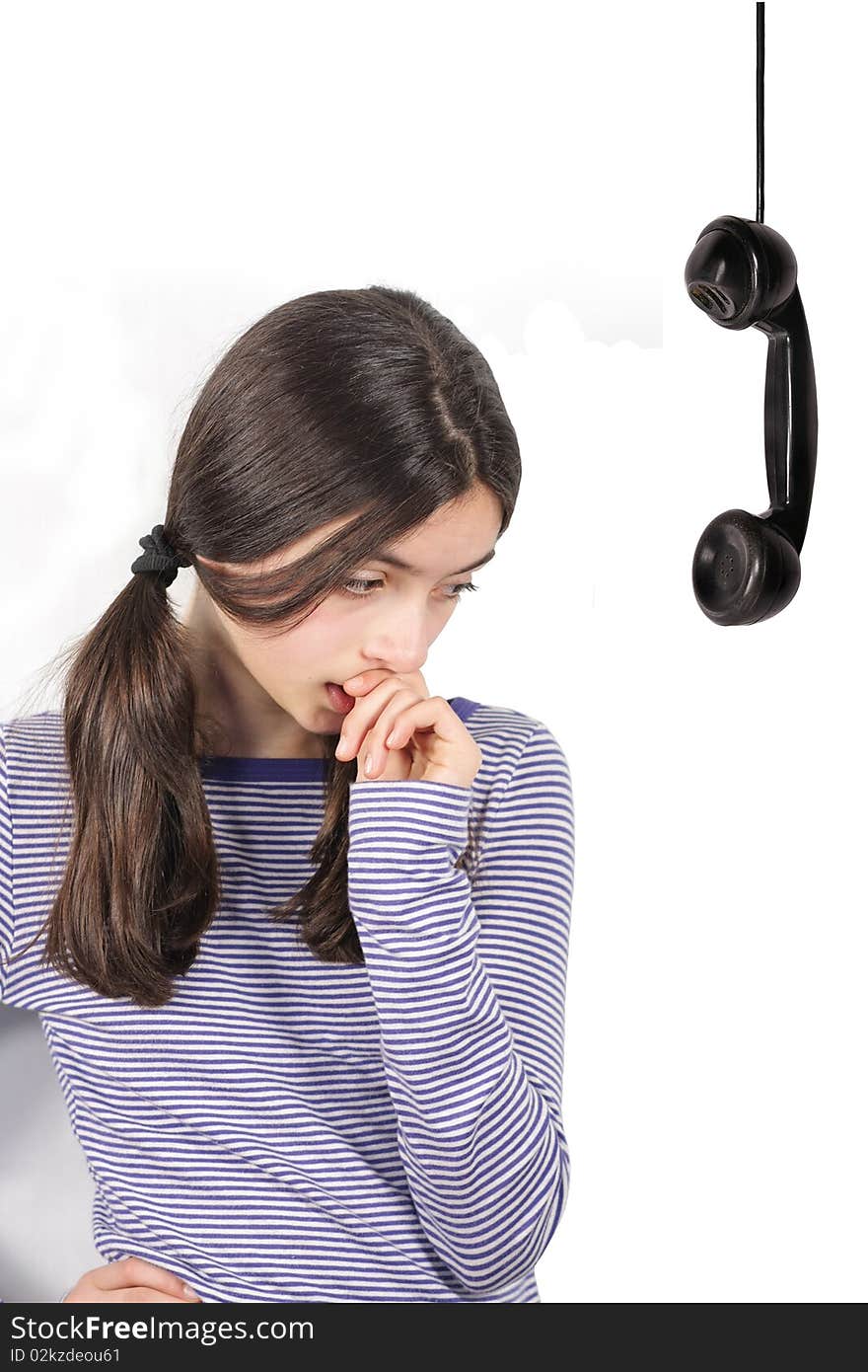 Thinking young girl and retro telephone receiver