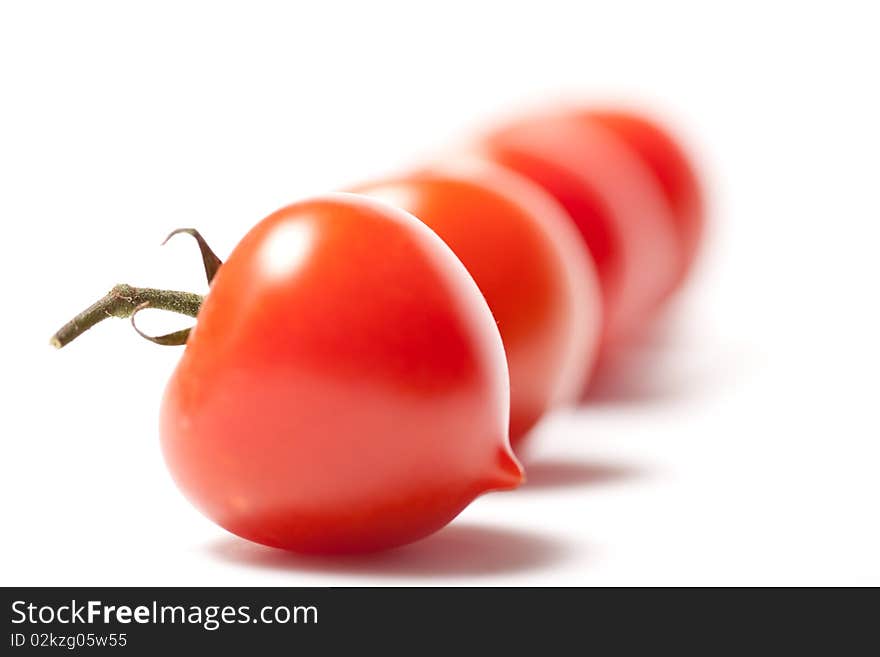 Cherry tomatoes queuing up in a straight line. Cherry tomatoes queuing up in a straight line