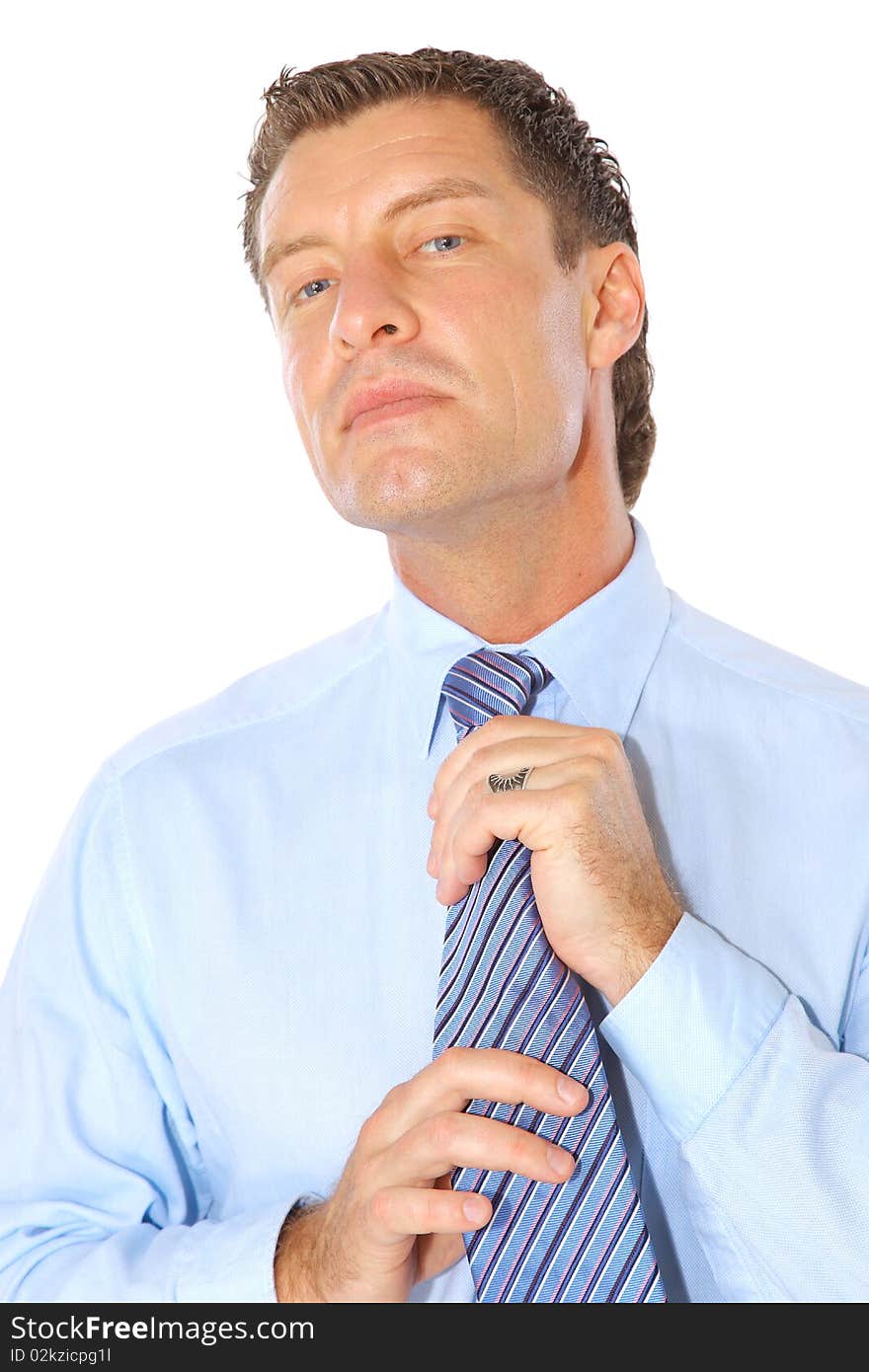 Portrait of a businessman fixing necktie