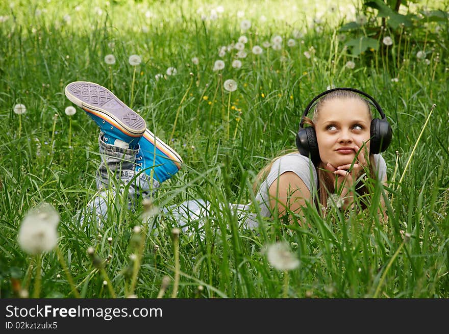 Girl listen music on meadow