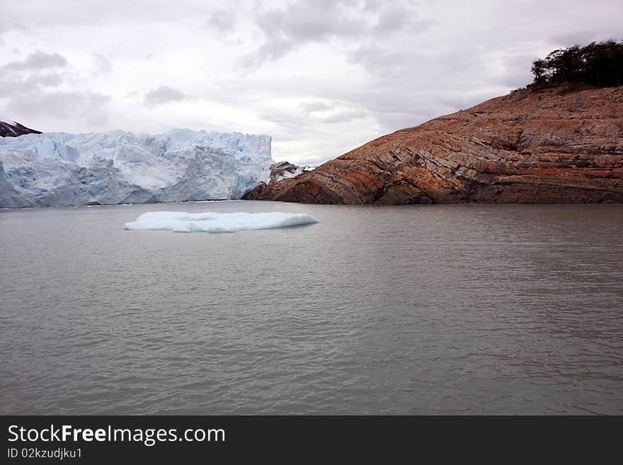 View to the connection of the glacier with nearby mountain. View to the connection of the glacier with nearby mountain