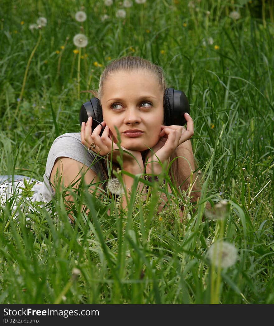 Girl listen music on meadow