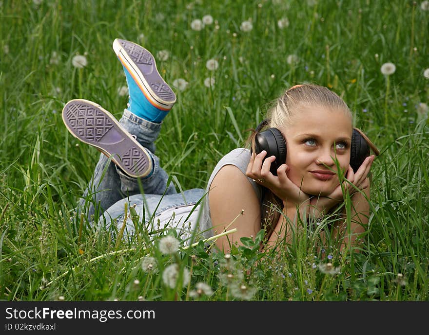 Girl listen music on meadow