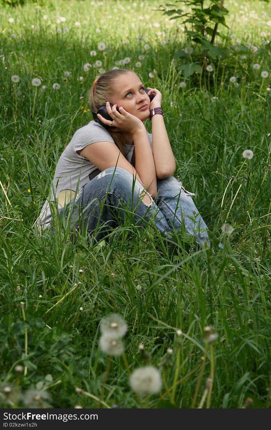 Girl listen music on meadow