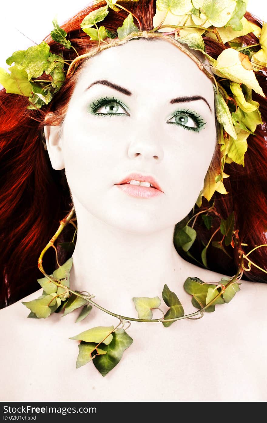 A beautiful young woman with ivy in her hair. A beautiful young woman with ivy in her hair.