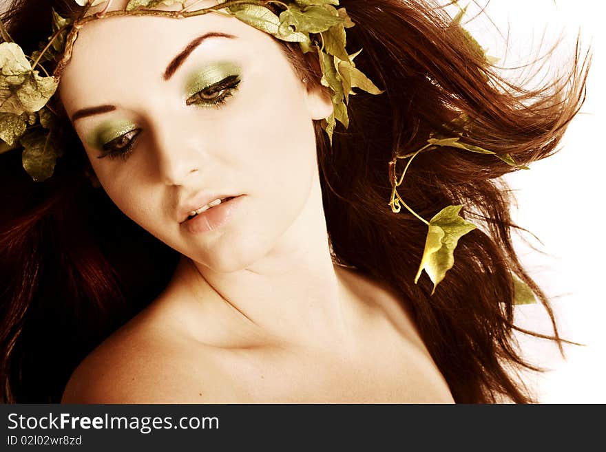 A beautiful young woman with ivy in her hair. A beautiful young woman with ivy in her hair.