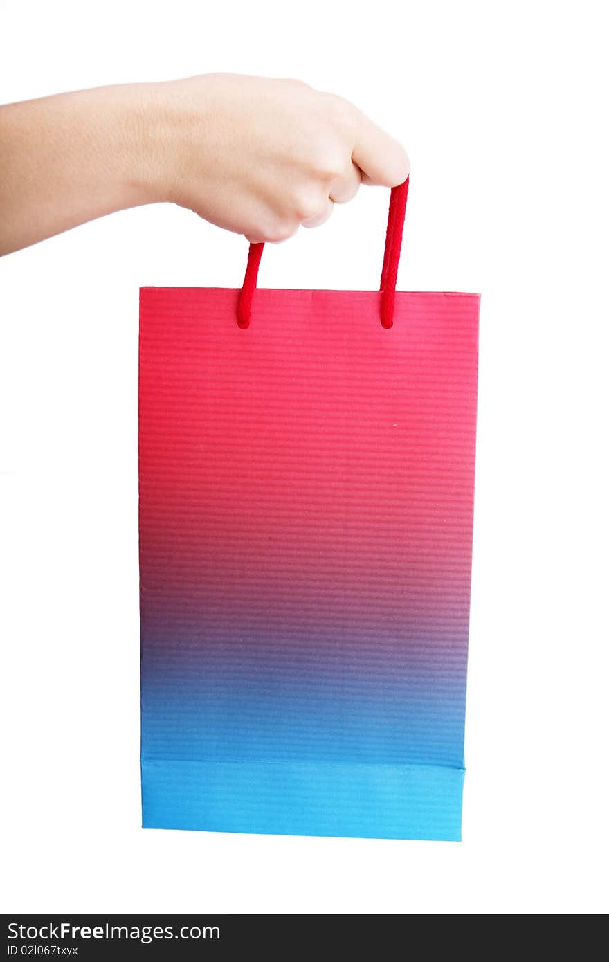 Hand holding a shopping bag over white background