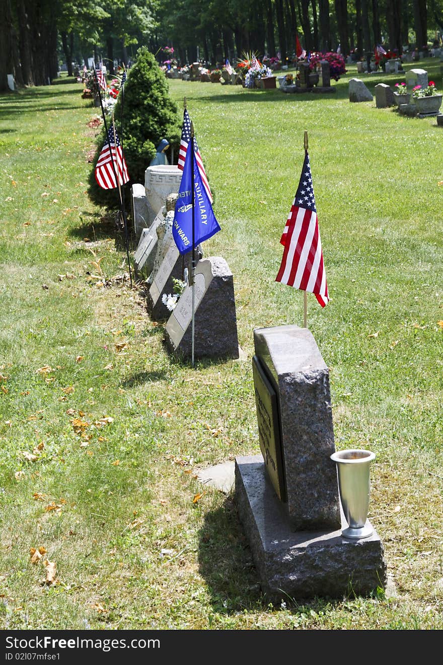 Flags and flowers stand out over the graves of loved ones. Flags and flowers stand out over the graves of loved ones