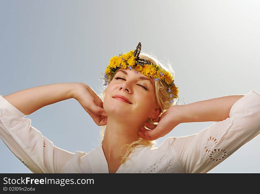 Lovely woman with a butterfly over blue sky