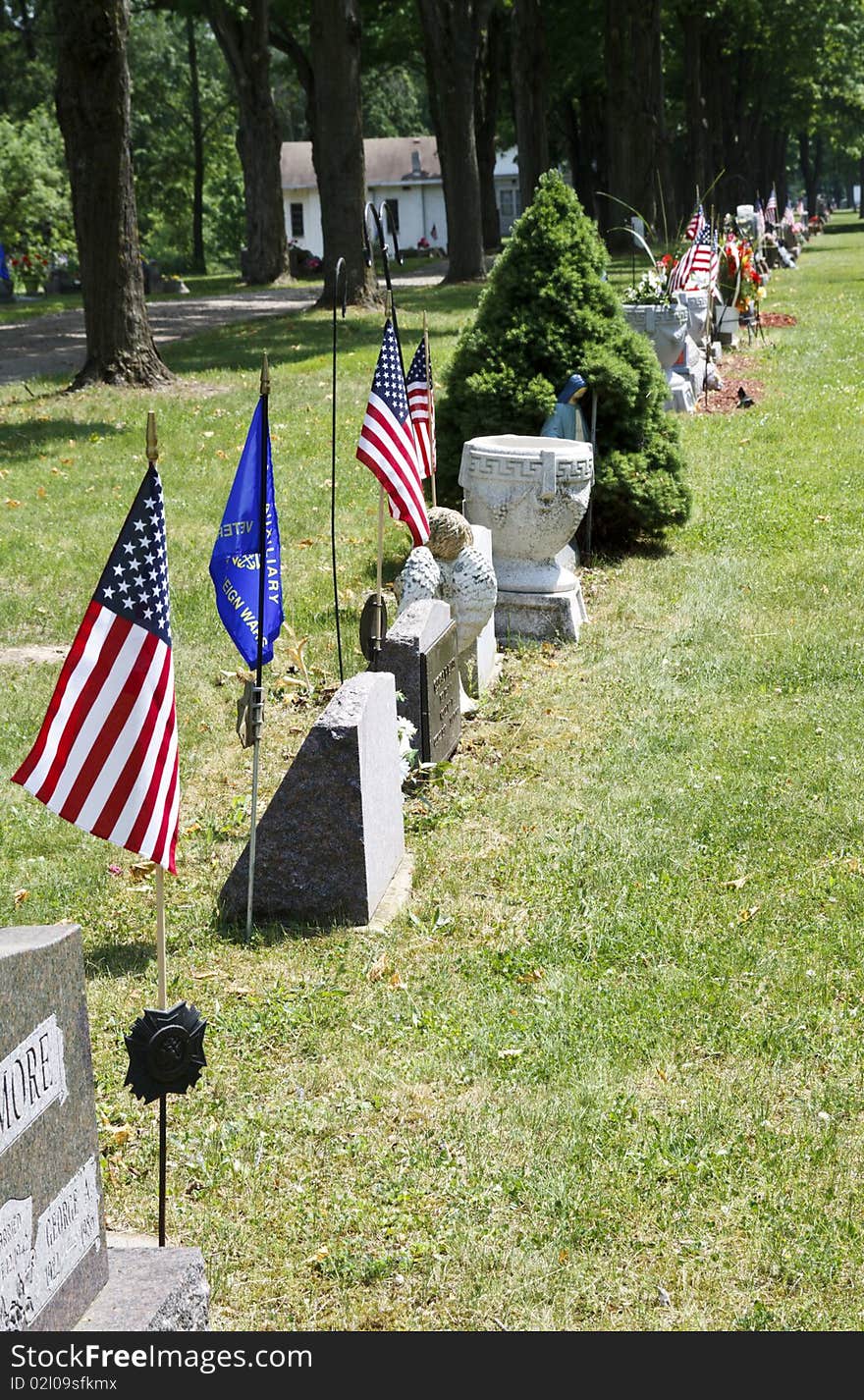 Flags and flowers stand out over the graves of loved ones. Flags and flowers stand out over the graves of loved ones