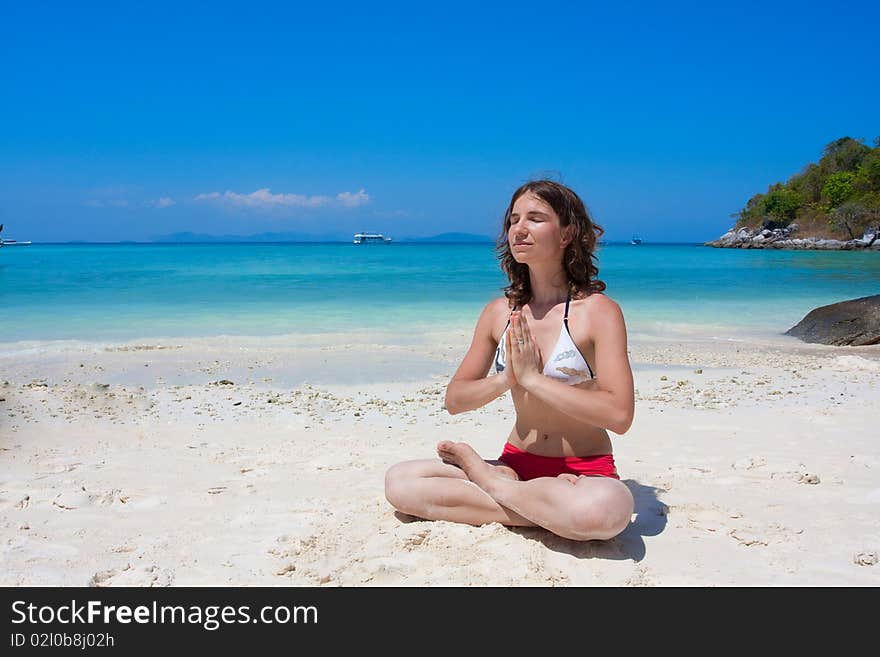 Woman going yogatsic exericise on the beach. Woman going yogatsic exericise on the beach