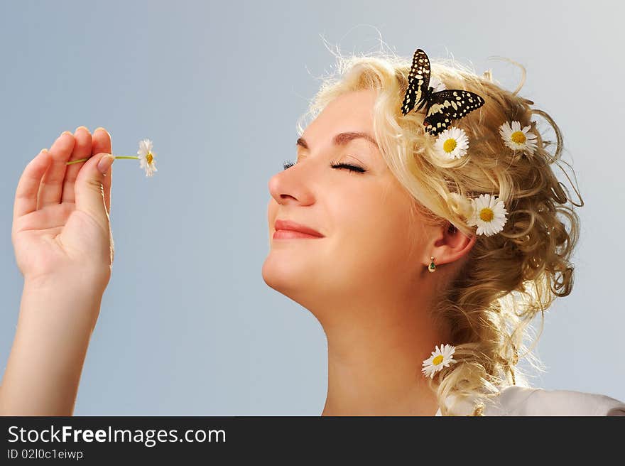 Lovely woman with a butterfly over blue sky