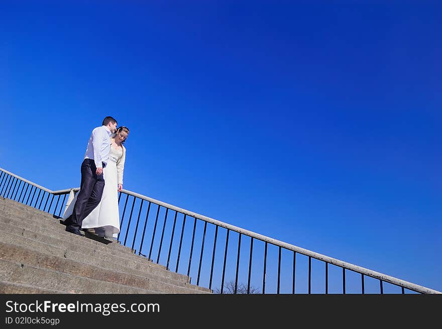 Newly-married couple comes downstairs and talks. Newly-married couple comes downstairs and talks