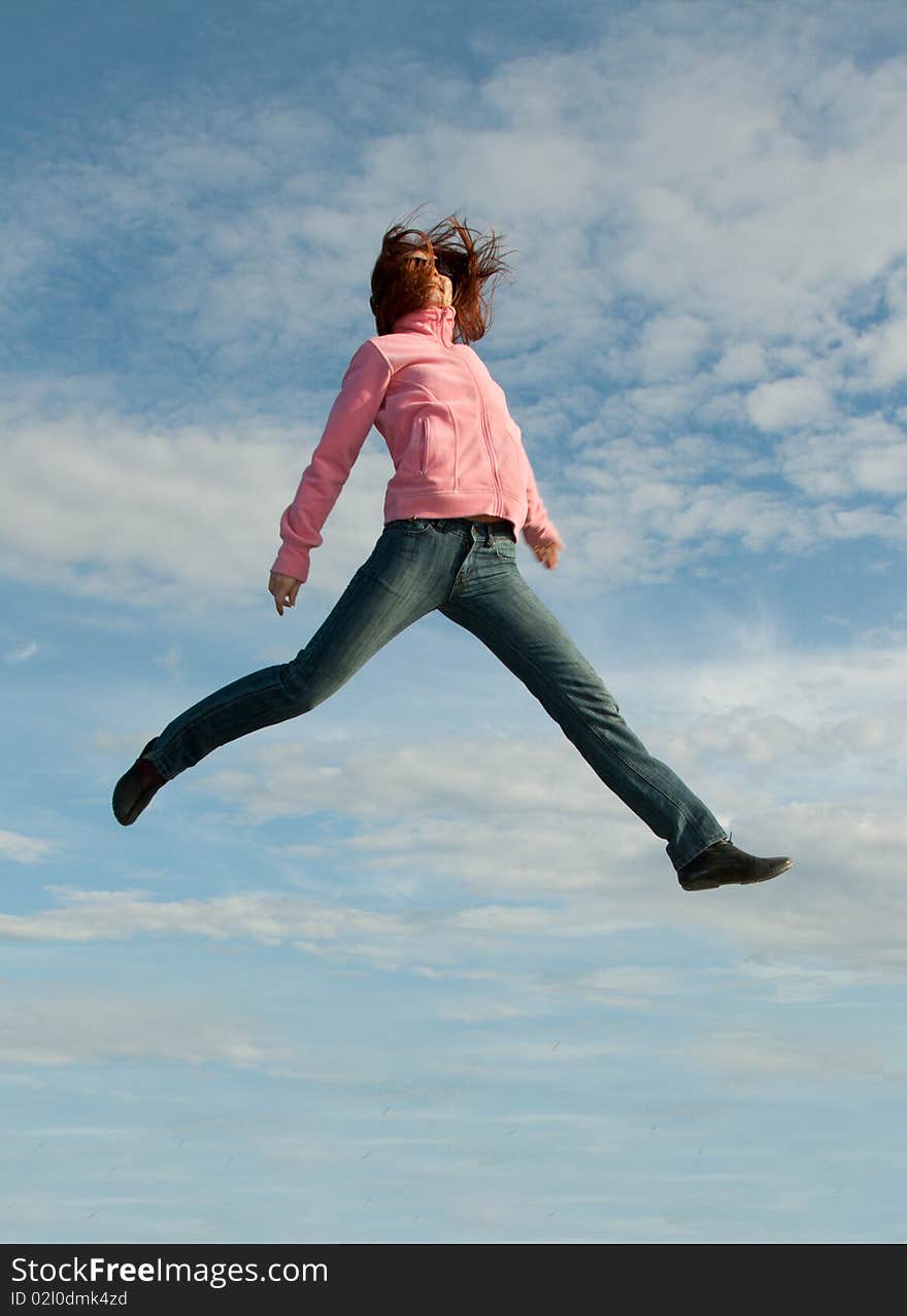 Girl in jump on background sky