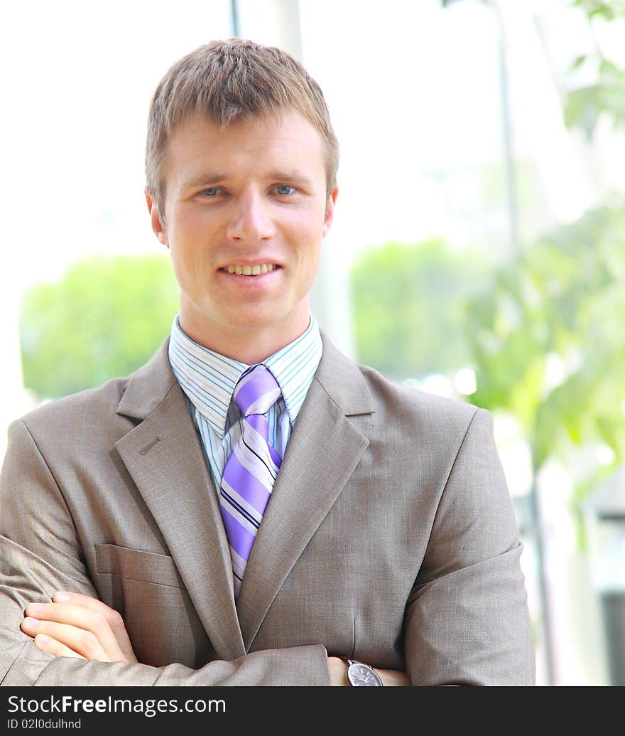 Portrait of a happy young businessman, smiling, indoor