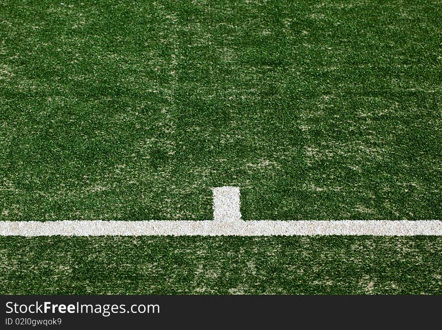 Close up of tennis court markings on a freshly laid turf.