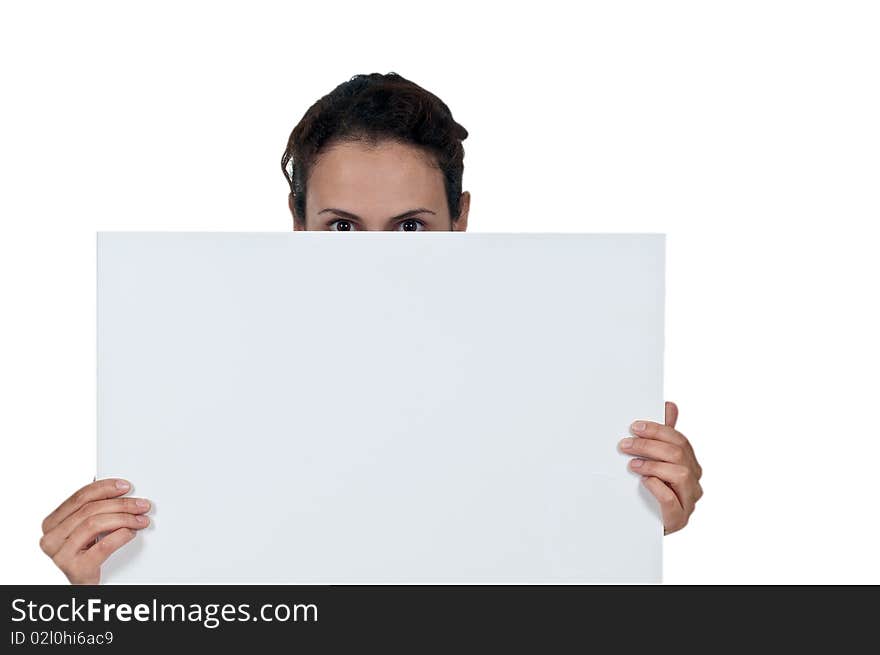 Portrait of woman's eyes peeking out from behind white sign. Portrait of woman's eyes peeking out from behind white sign