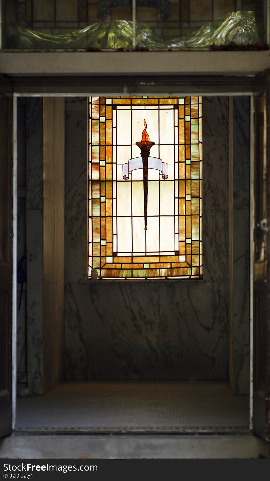 Entrance to the crypt with a stained glass window in the background