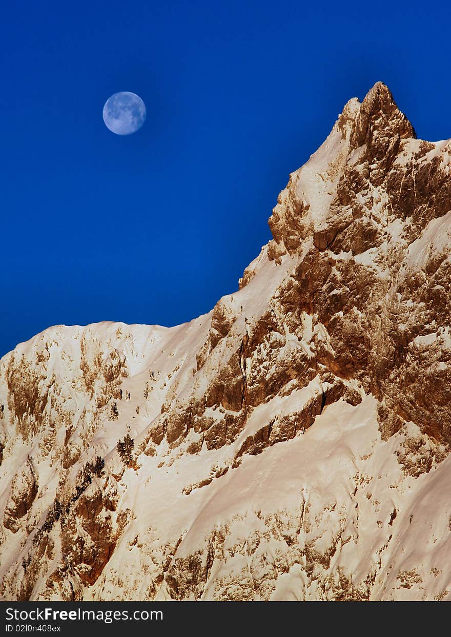 High alpine mountain with the moon. High alpine mountain with the moon