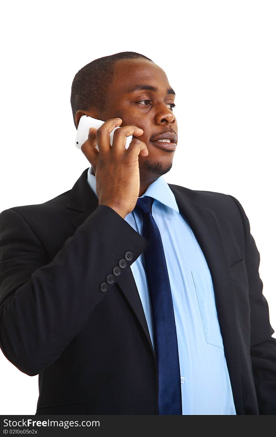 Young entrepreneur holding his coat over shoulder while talking on cell phone