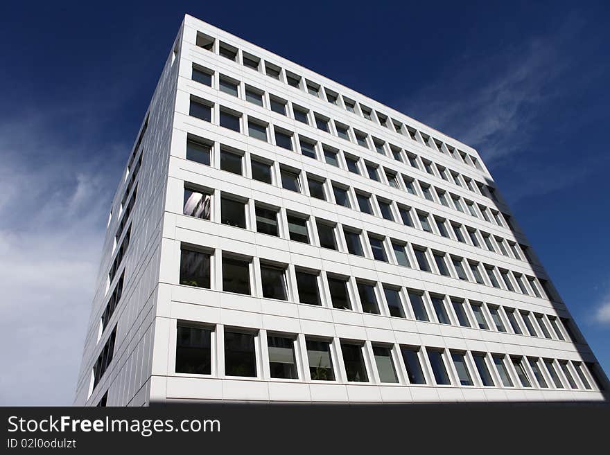 Fancy business building in a financial district. Many windows and summer look.