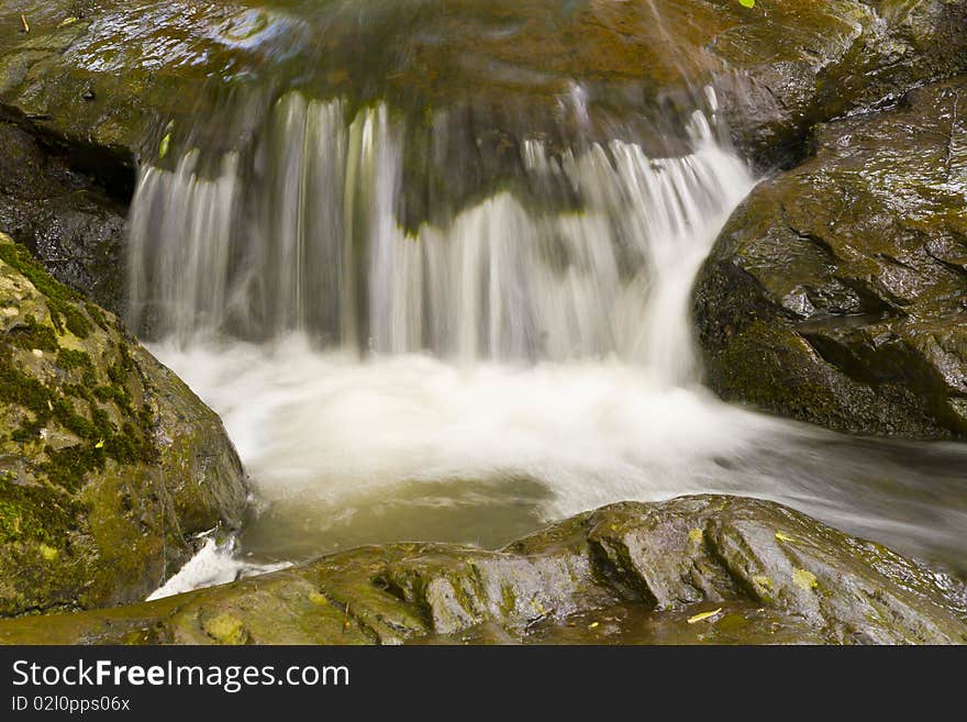 Beautiful waterfalls in the rocky river bed.