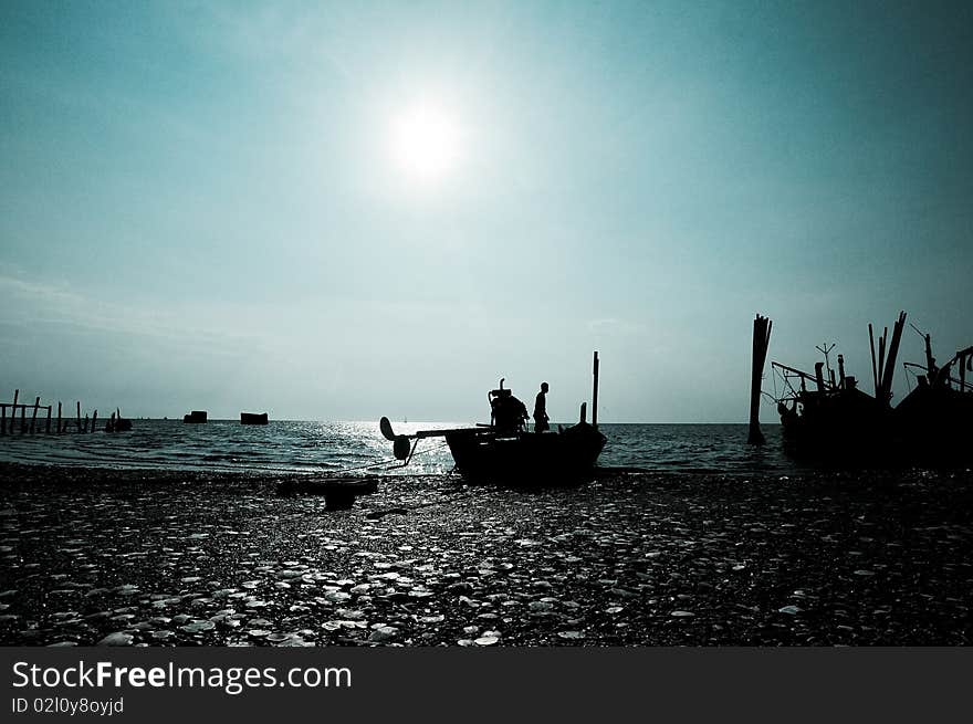 A fisherman cleaning his boat after a day's fishing in the open ocean. A fisherman cleaning his boat after a day's fishing in the open ocean