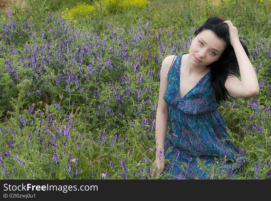 Beautiful Brunette Girl  with  Blue Dress in Blue Flowers