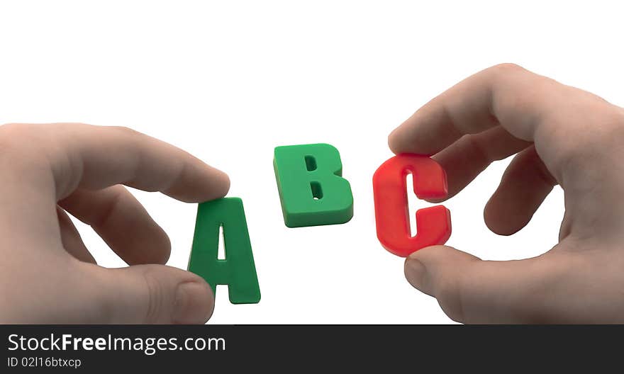 Children's hands folded word of plastic letters on a white background. Children's hands folded word of plastic letters on a white background