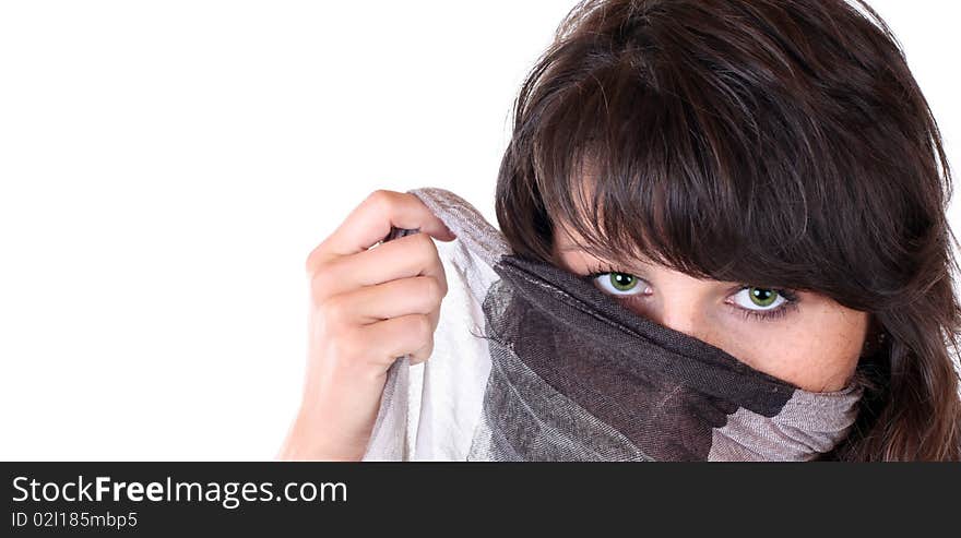 Beautiful woman is hiding her face behind a scarf. photo is isolated in front of a white background. Beautiful woman is hiding her face behind a scarf. photo is isolated in front of a white background