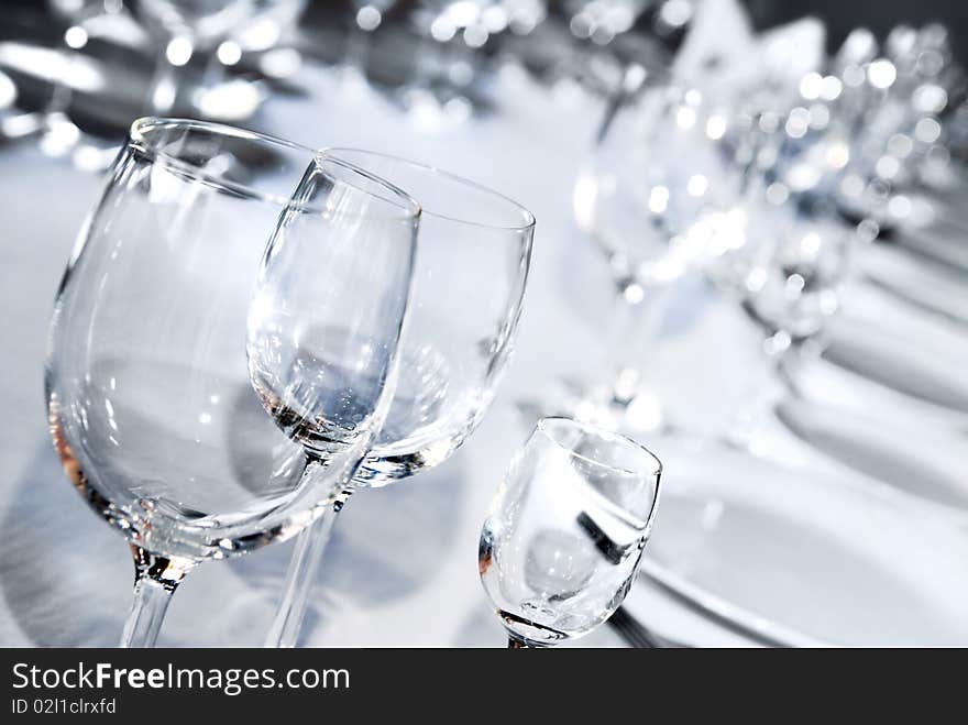 Glass goblets on white table