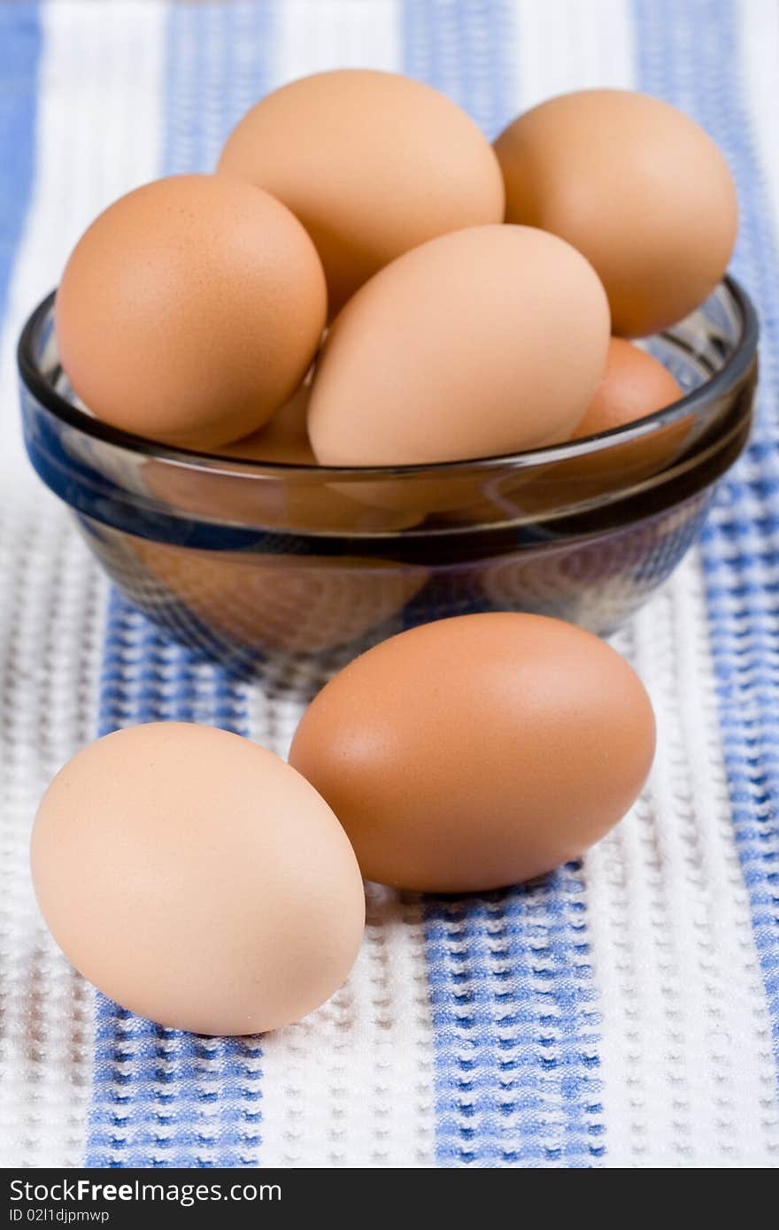 Brown eggs in a bowl on a napkin closeup