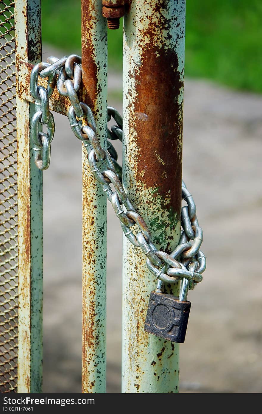 Old rusty gates closed wiyh chain and  padlock