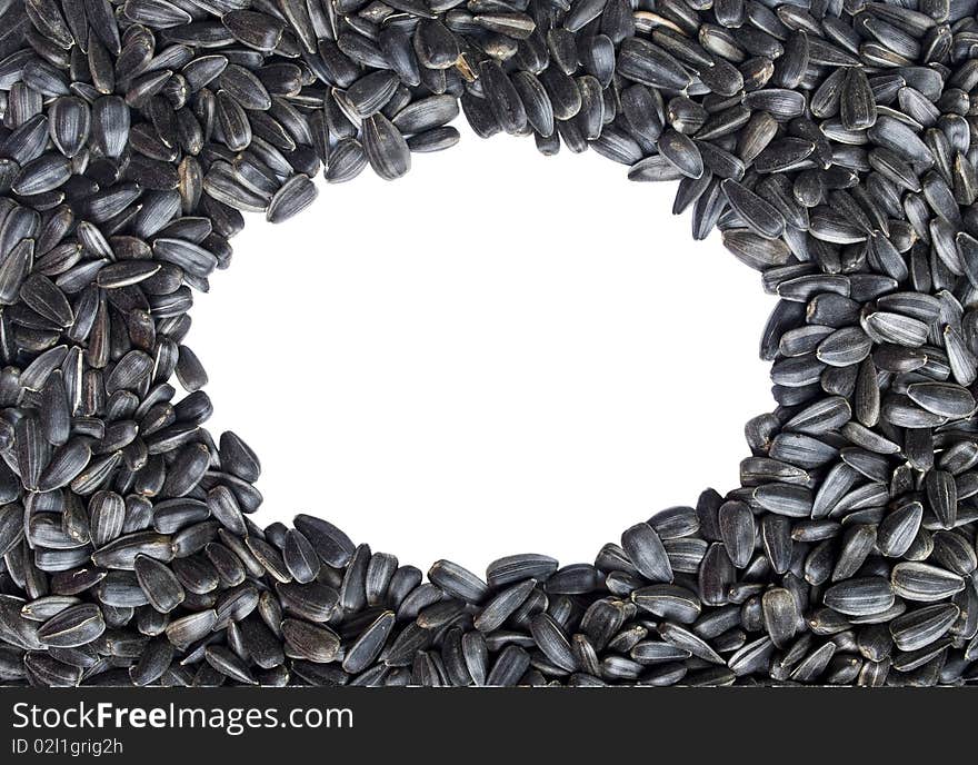 Oval frame made of sunflower seeds. Isolated over white background