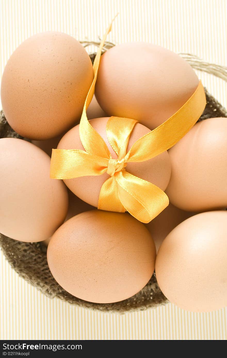 Many eggs are in one egg sack tied with yellow ribbon. Top view