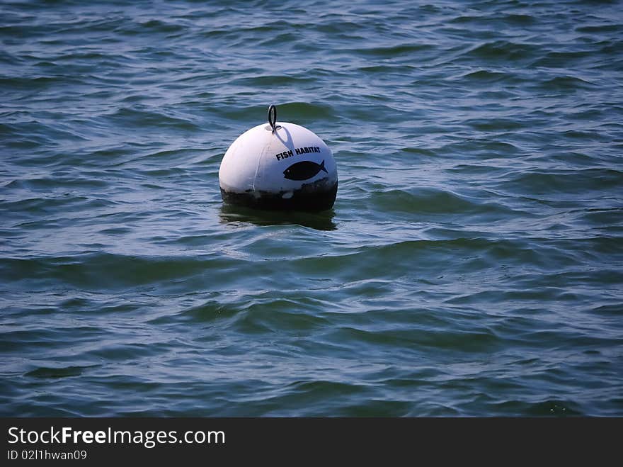 A warning buoy in local lake warning fisherman to not fish in the habitat zone. A warning buoy in local lake warning fisherman to not fish in the habitat zone