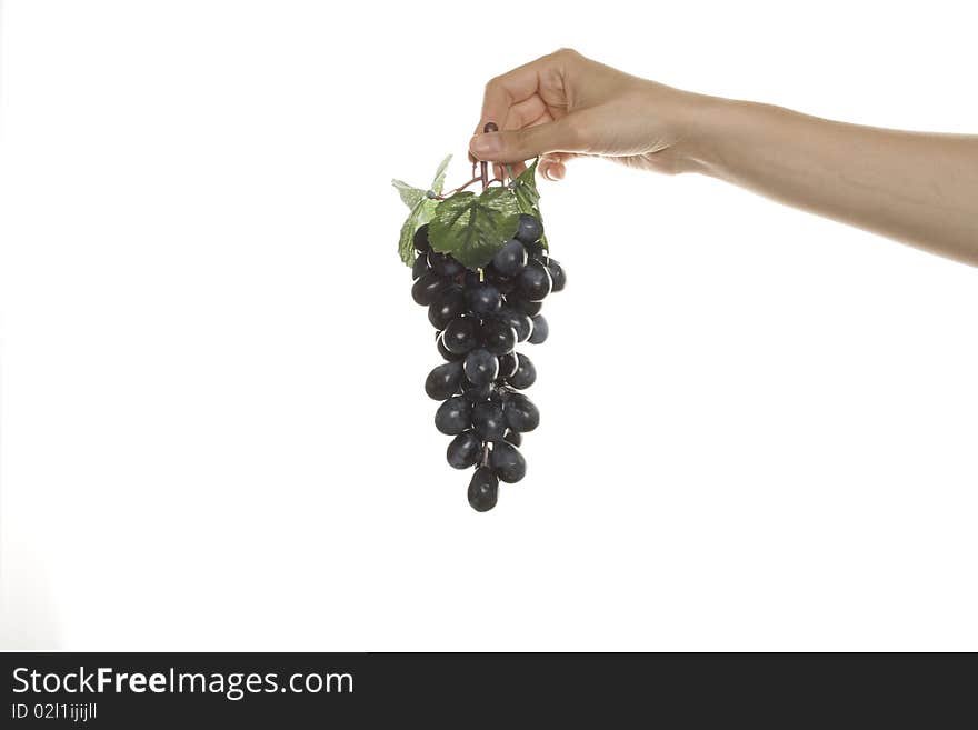 Artificial branch of grapes in his hand women. Artificial branch of grapes in his hand women