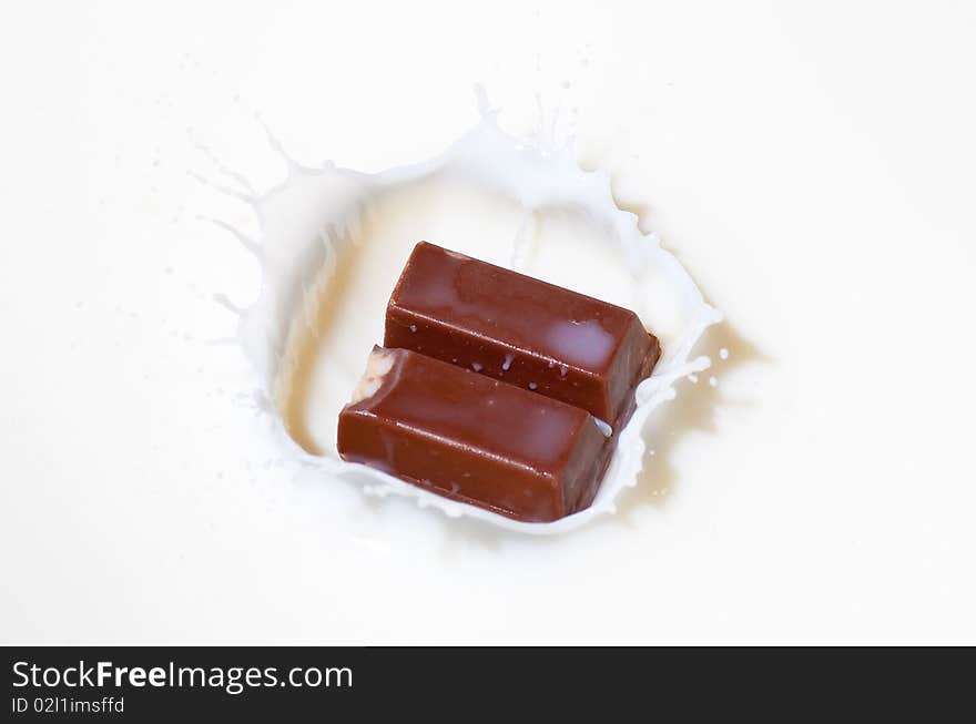 Chocolate candy splashing into milk