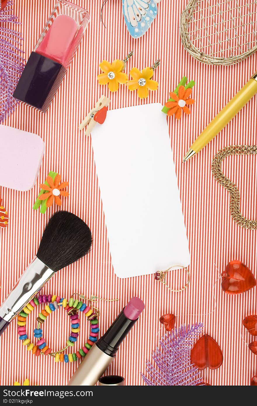 Background for Women's Day in pink. Lipstick, earrings, ring, red heart, nail polish, flowers, perfume, sparkles, white sheet of paper and pen gold. Background for Women's Day in pink. Lipstick, earrings, ring, red heart, nail polish, flowers, perfume, sparkles, white sheet of paper and pen gold