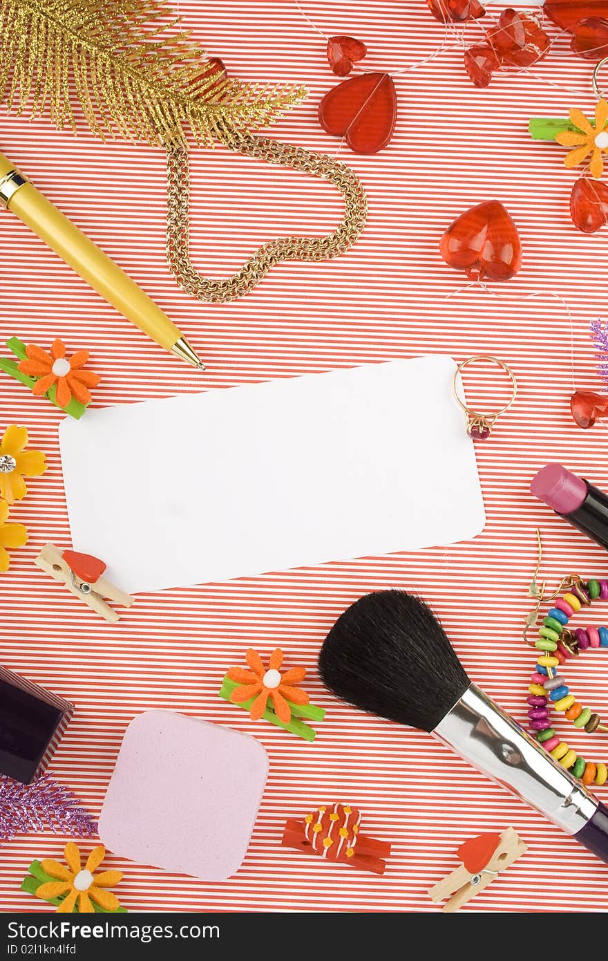 Background for Women's Day in pink. Lipstick, earrings, ring, red heart, nail polish, flowers, perfume, sparkles, white sheet of paper and pen gold. Background for Women's Day in pink. Lipstick, earrings, ring, red heart, nail polish, flowers, perfume, sparkles, white sheet of paper and pen gold