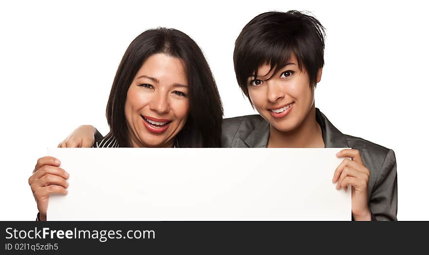 Attractive Multiethnic Mother and Daughters Holding Blank White Sign Isolated on a White Background. Attractive Multiethnic Mother and Daughters Holding Blank White Sign Isolated on a White Background.